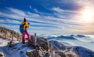 Woman hiker taking mountain photo